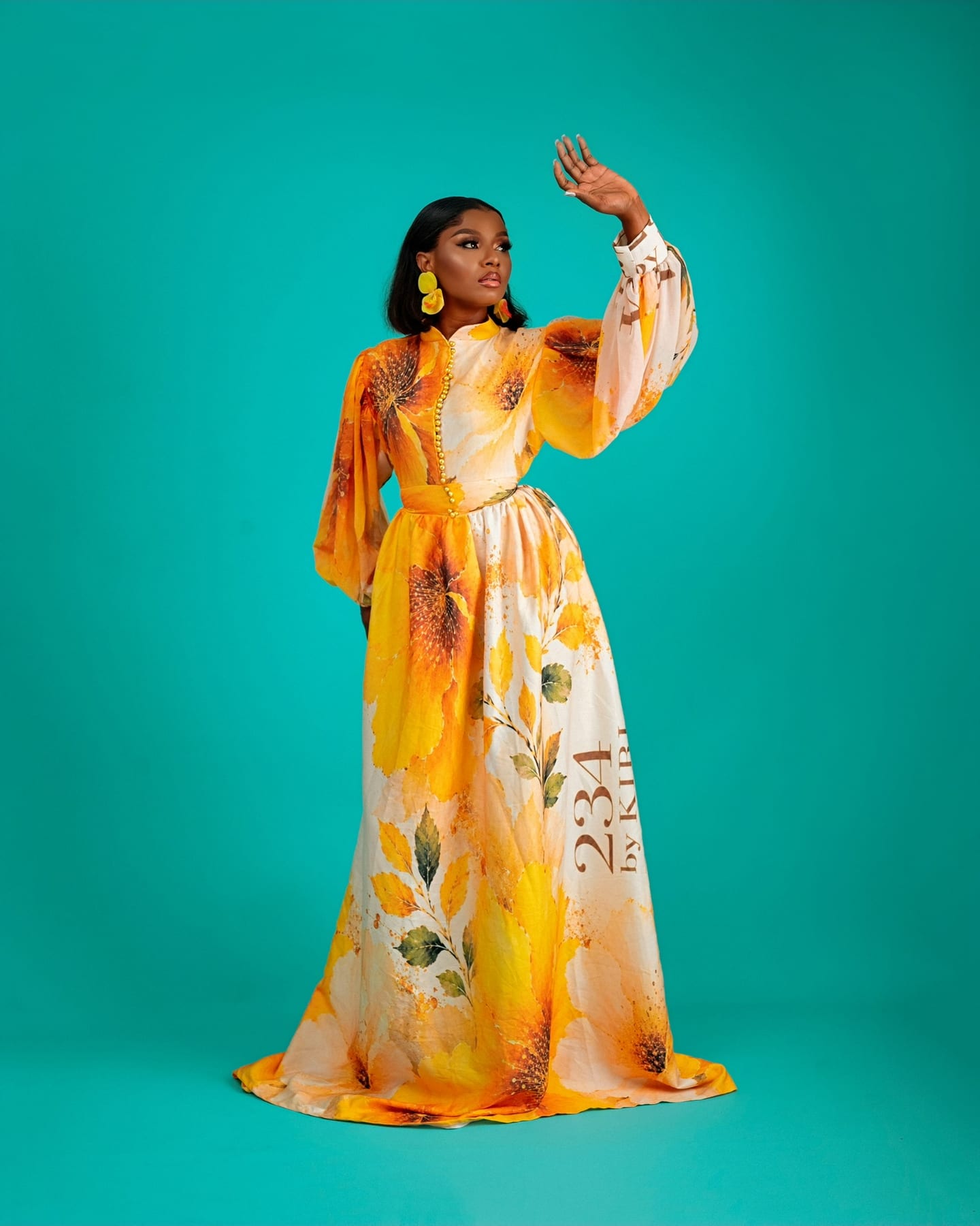 Teal floral Bloom Royale gown on the studio floor (frame 2 of 9)