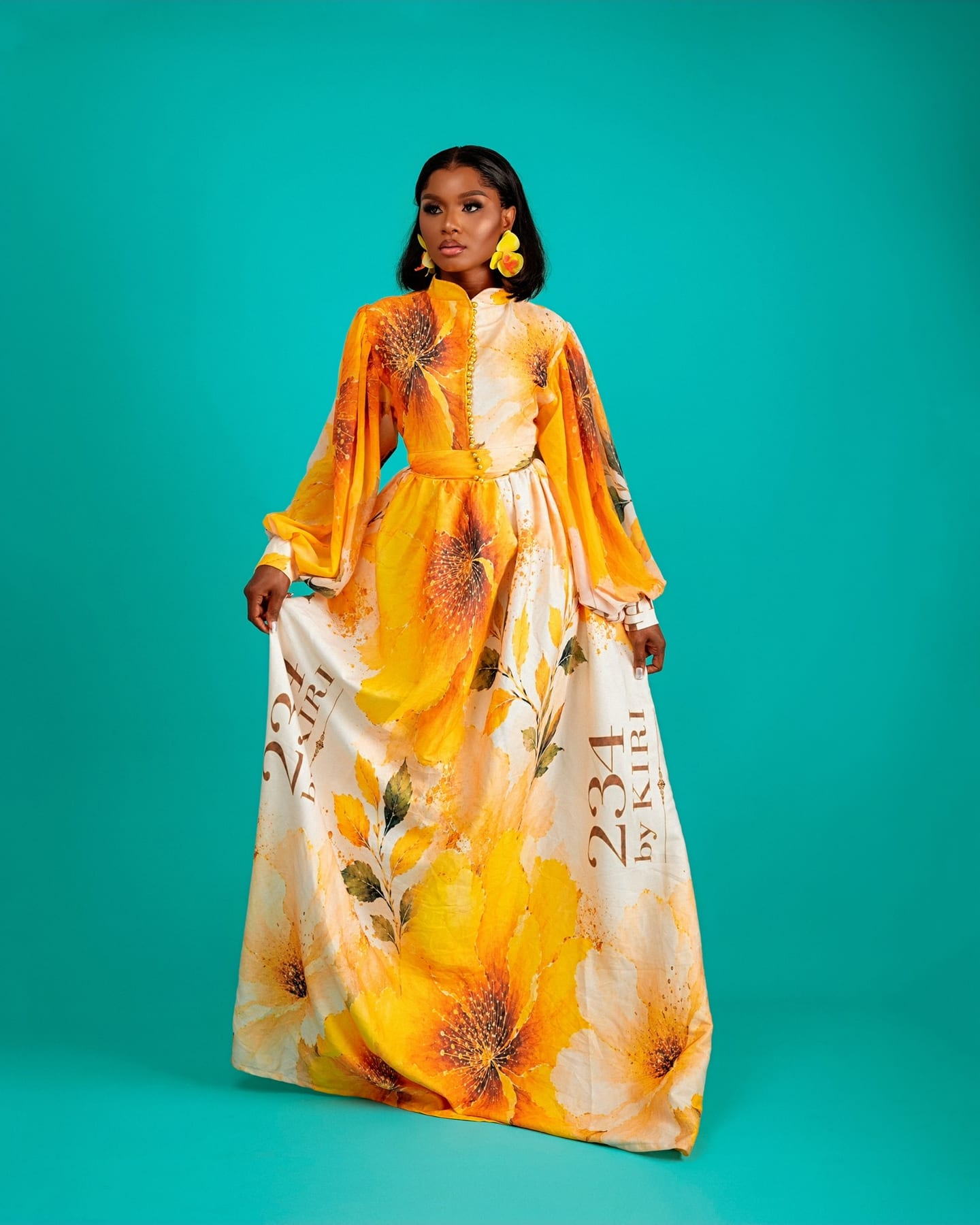 Teal floral Bloom Royale gown on the studio floor (frame 3 of 9)