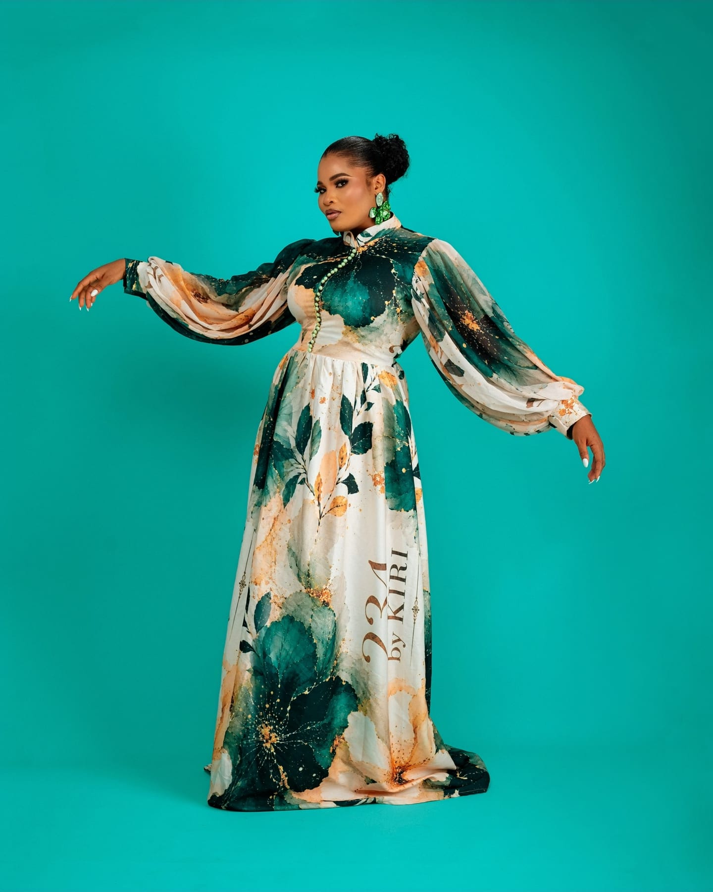 Teal floral Bloom Royale gown on the studio floor (frame 5 of 9)